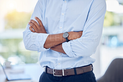 Buy stock photo Shot of an unrecognizable businessperson standing with their arms crossed in an office at work