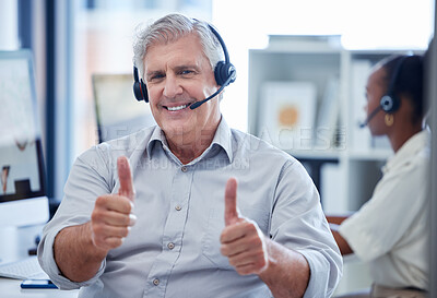 Buy stock photo Portrait of a mature call centre agent showing thumbs up in an office