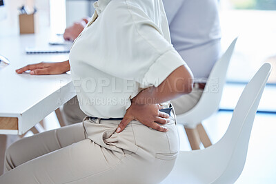 Buy stock photo Closeup shot of an unrecognisable businesswoman experiencing lower back pain while working in an office