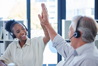 Buy stock photo Shot of a young call centre agent giving her colleague a high five in an office