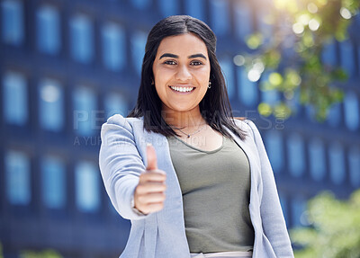 Buy stock photo Portrait of a young businesswoman showing thumbs up in the city