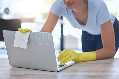 Buy stock photo Shot of an unrecognizable woman carefully cleaning a laptop at home