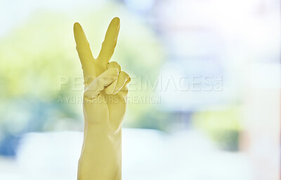 Buy stock photo Shot of an unrecognizable woman showing the peace sign while wearing a protective glove