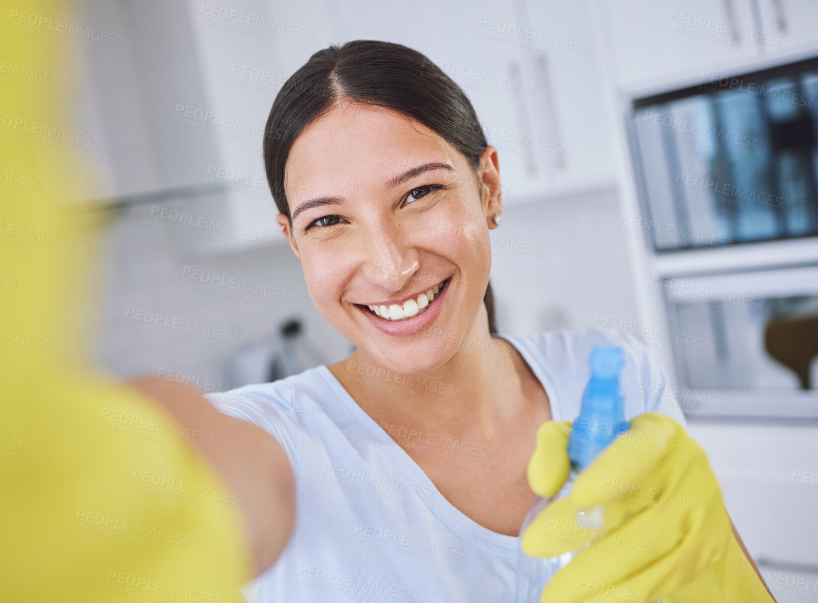 Buy stock photo Shot of a young woman cleaning her apartment
