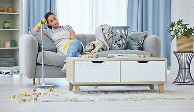 Buy stock photo Shot of a young woman looking tired while cleaning at home