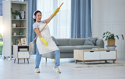 Buy stock photo Shot of a young woman dancing while mopping the floors at home