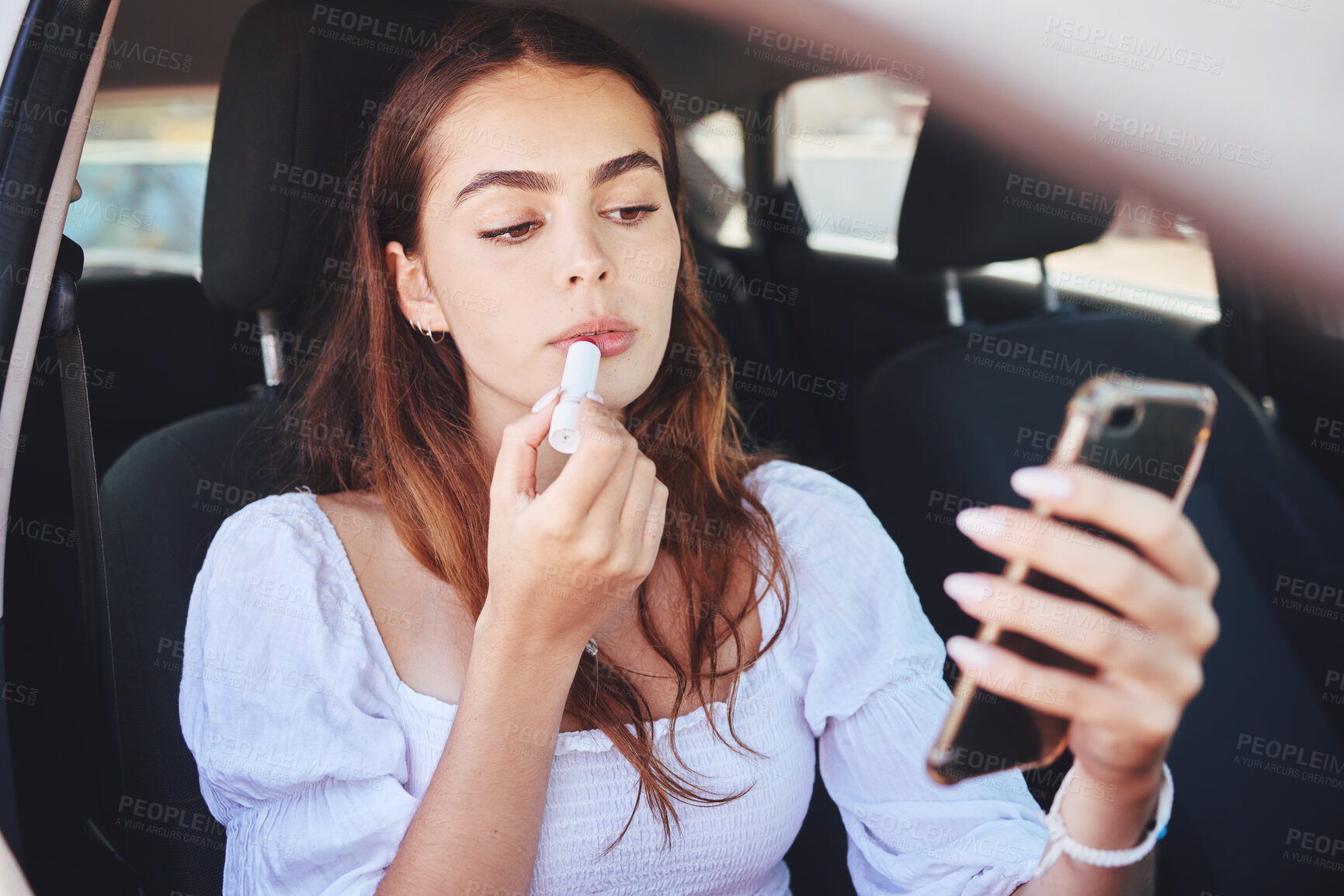 Buy stock photo Car, woman and applying lipstick with smartphone for beauty, aesthetics and makeup for romantic date. Female person, lifestyle and confident on vehicle for traveling or commuting to event or function