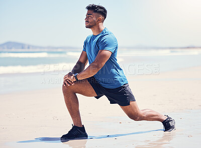 Buy stock photo Shot of a man stretching during his workout at the beach