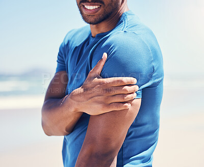 Buy stock photo Shot of a man experiencing discomfort in his arm while out for a workout