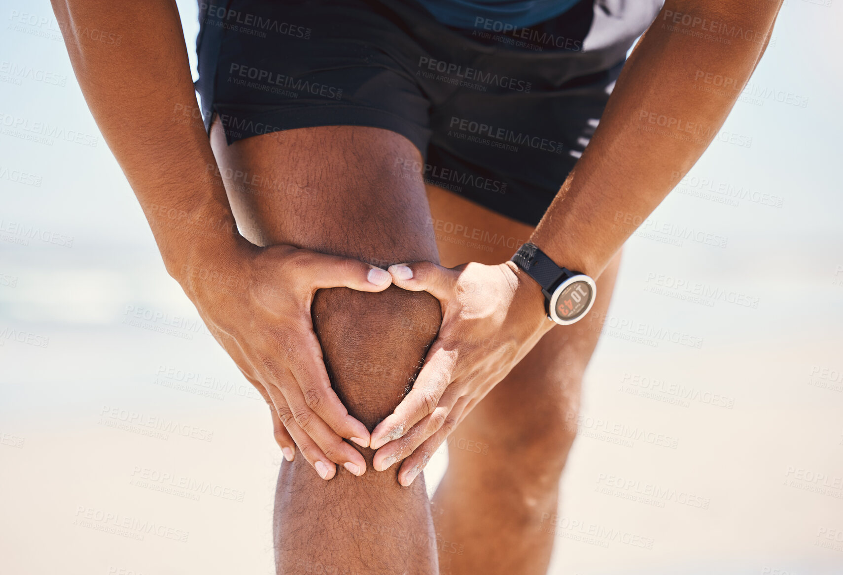 Buy stock photo Shot of a man experiencing discomfort in his knee while out for a workout