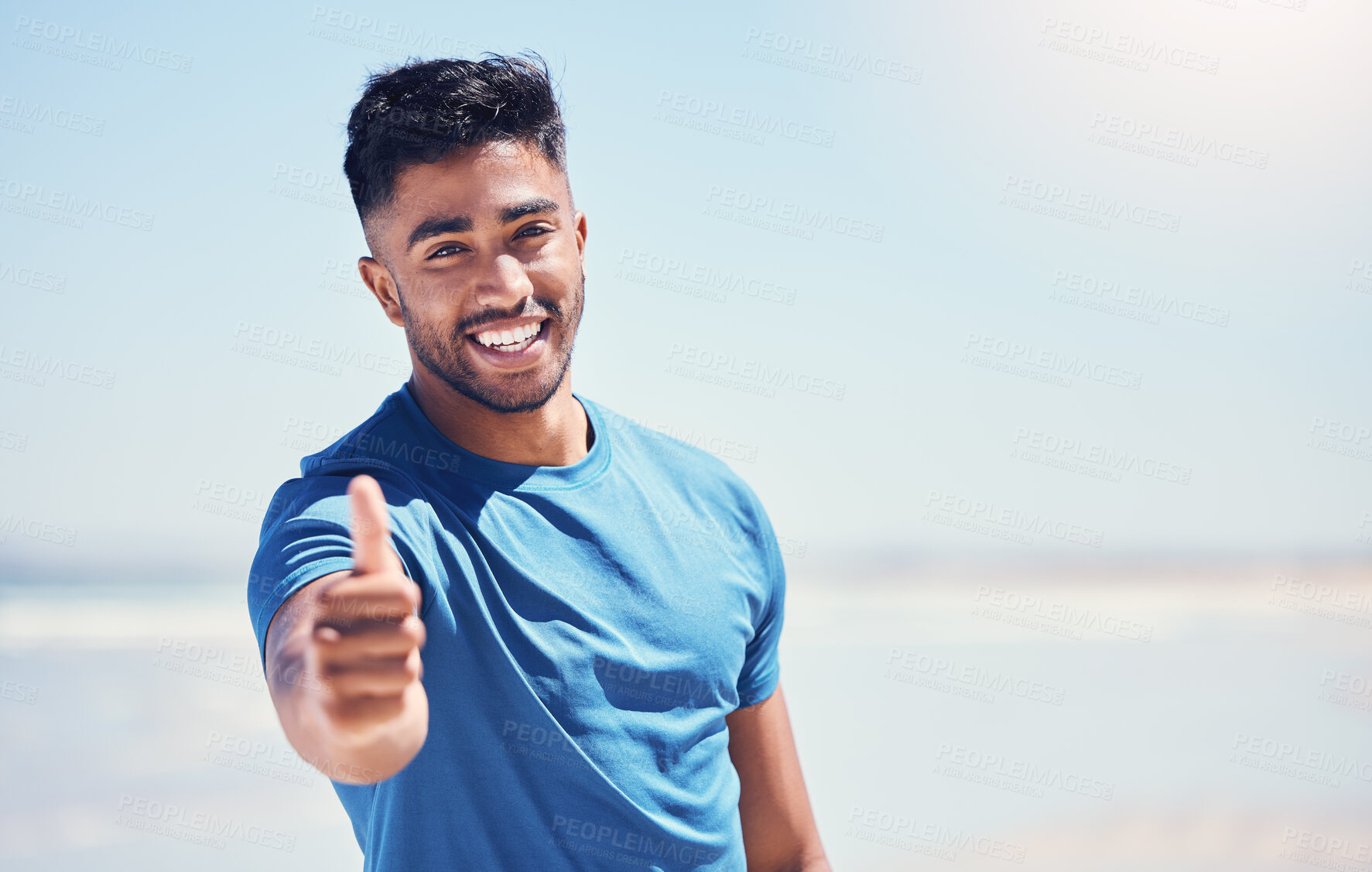 Buy stock photo Man, beach and happy with thumbs up for fitness with satisfaction for workout and exercise in Brazil. male person, outdoor and smile in ocean for running for wellness, wellbeing and health or care