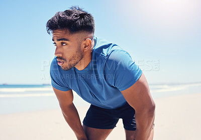 Buy stock photo Shot of a man taking a break while out for a run on the beach