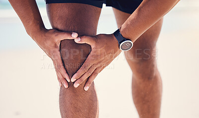 Buy stock photo Shot of a man experiencing discomfort in his knee while out for a workout
