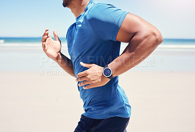 Buy stock photo Cropped shot of a man running along the beach