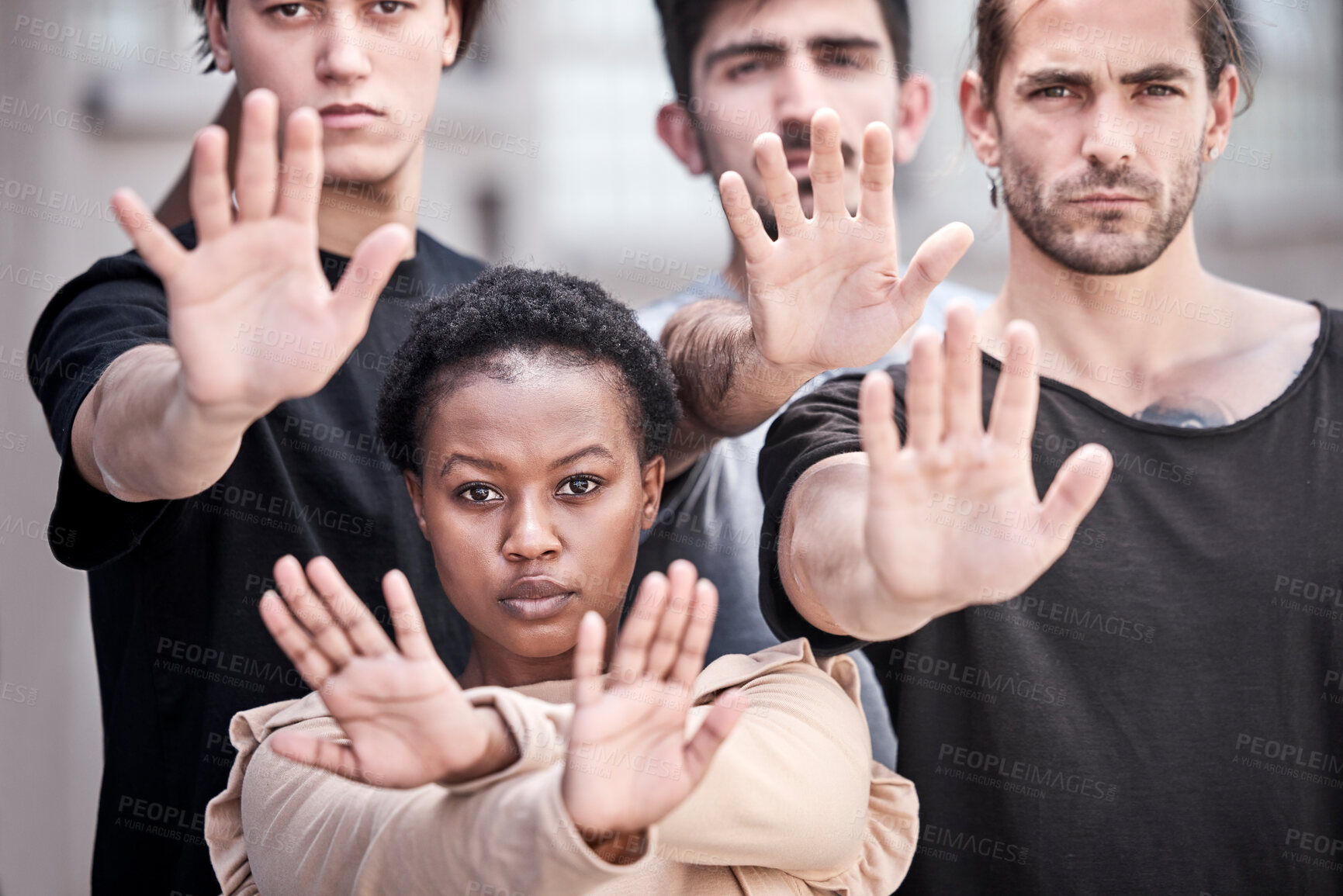Buy stock photo Shot of a group of protestors raising their hands