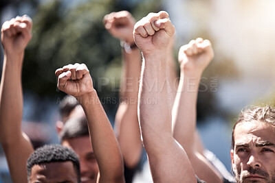 Buy stock photo Shot of a group of protestors with their fists raised