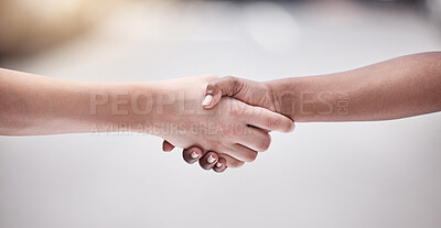 Buy stock photo Shot of two protestors shaking hands during a rally