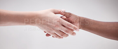 Buy stock photo Shot of two protestors shaking hands during a rally