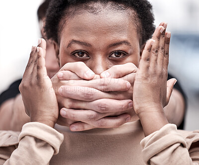 Buy stock photo Shot of a young woman being silenced during a protest