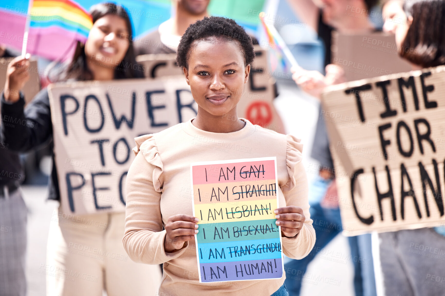 Buy stock photo Woman, portrait and group for protest with lgbtq community, rainbow and poster for inclusion in street. Girl, person and paper sign for support, equality and pride in crowd for call to action in city