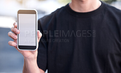 Buy stock photo Shot of a man using his smartphone during a protest