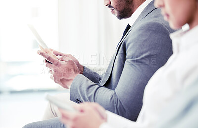 Buy stock photo Closeup shot of an unrecognisable businessman using a digital tablet while sitting in line in an office