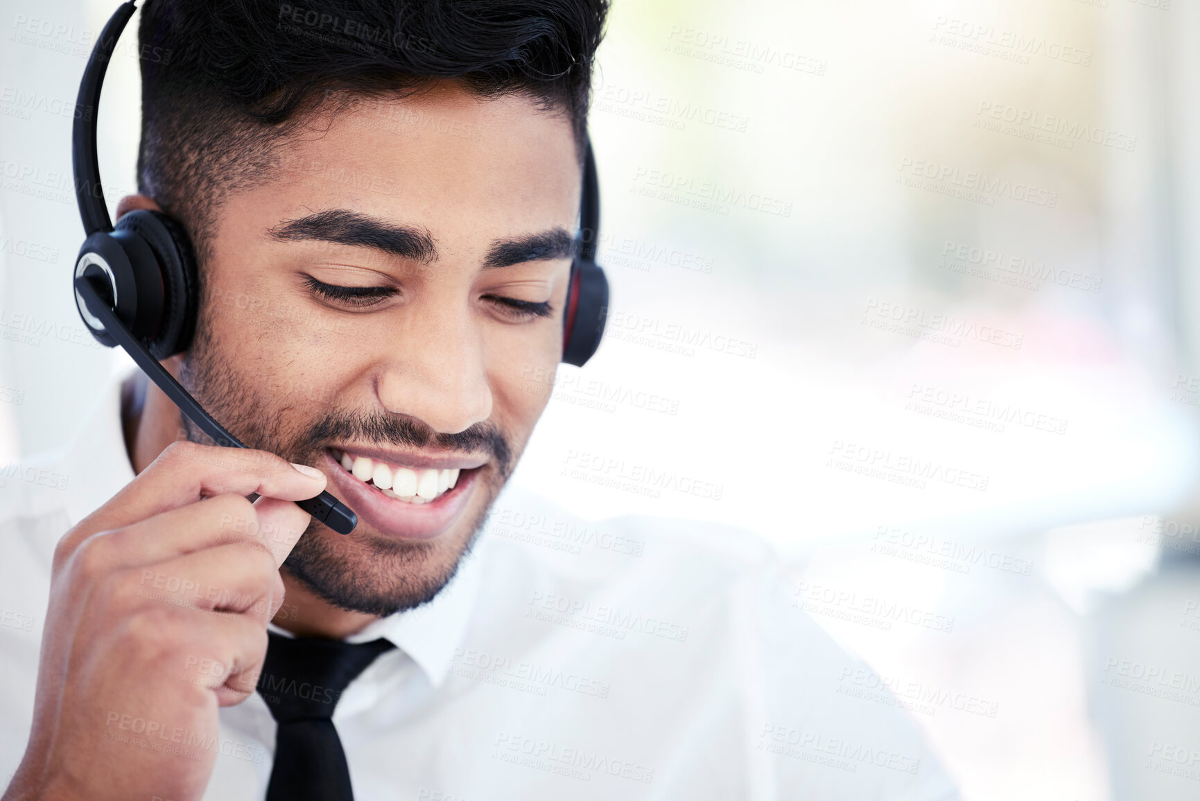 Buy stock photo Shot of a young call centre agent working in an office