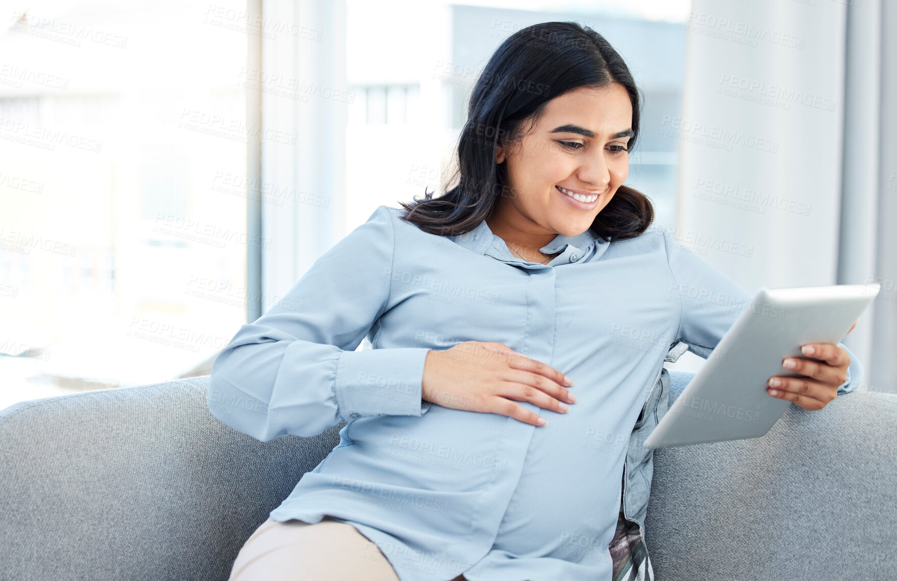 Buy stock photo Sofa, pregnant woman and smile with tablet for reading, schedule and digital for medical appointment. Home, pregnancy and motherhood for female person with technology, research and parenting tips