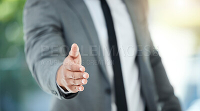 Buy stock photo Cropped shot of an unrecognizable businessman reaching out for a handshake while standing in his office