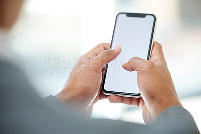 Buy stock photo Cropped shot of an unrecognizable businessman using his cellphone while standing in the office