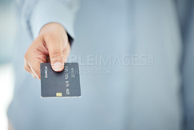 Buy stock photo Cropped shot of an unrecognizable businesswoman holding out her credit card while standing in the office