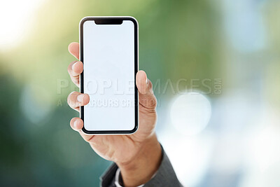 Buy stock photo Cropped shot of an unrecognizable businessman holding up his cellphone to display the screen while standing in the office