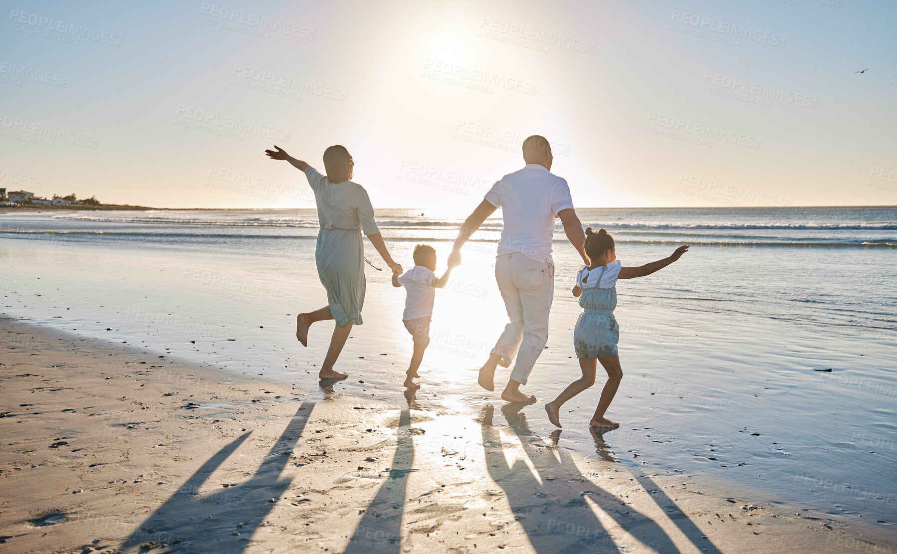 Buy stock photo Running, waves and parents with children at beach for bonding on summer holiday, vacation and weekend. Morning, family and back of mom, dad and kids for fun, adventure and relax outdoors in nature