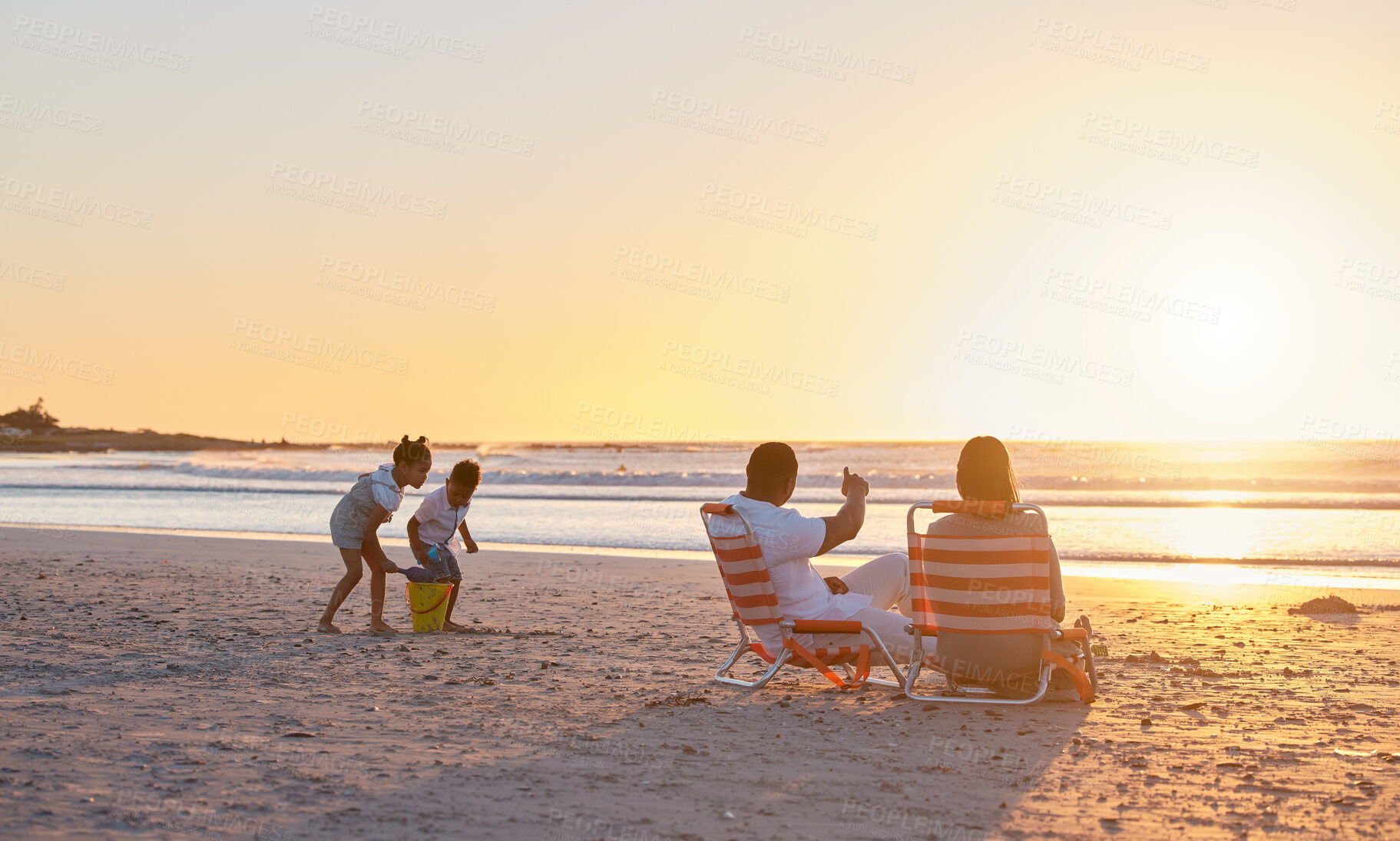 Buy stock photo Parents, siblings or children at beach for sunset, holiday or travel on break with boy, girl or family. Playing, mom or father with kids at sea on vacation together for wellness or nature to relax