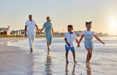 Buy stock photo Shot of a beautiful family bonding while spending a day at the beach together