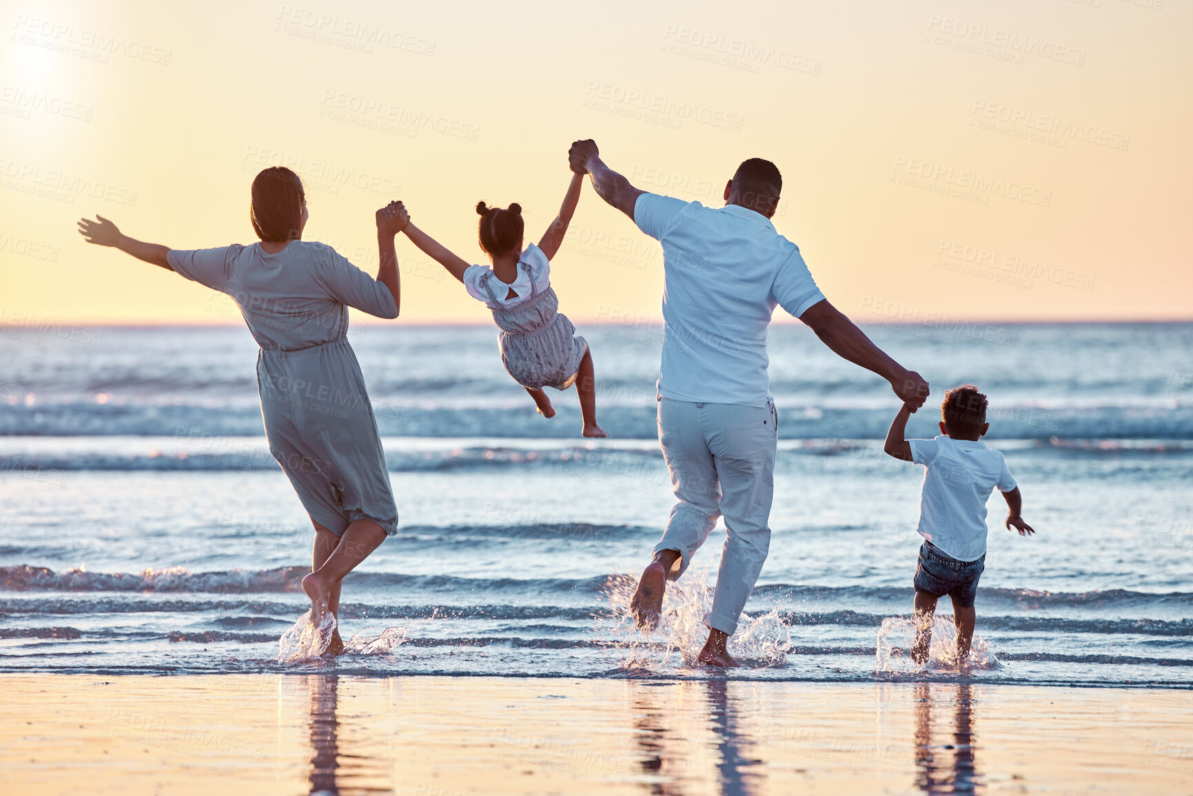 Buy stock photo Parents, running or children at beach for holding hands, holiday or travel on break with back view or family. Playing, mom or dad with kids at sea on vacation together for wellness, swing or nature