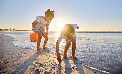 Buy stock photo Shot of a young brother and sister bonding at the beach