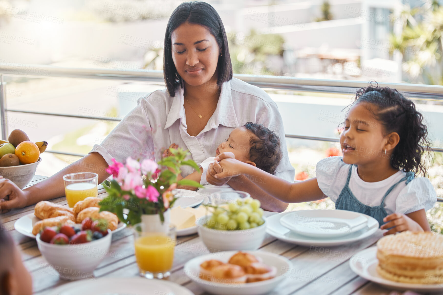 Buy stock photo Prayer, mother and children holding hands at breakfast with love, thanks and morning bonding together. Woman, kids and food at table with faith, gratitude and Christian family in home for brunch.