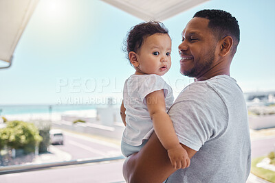 Buy stock photo Shot of a young father holding his daughter outside