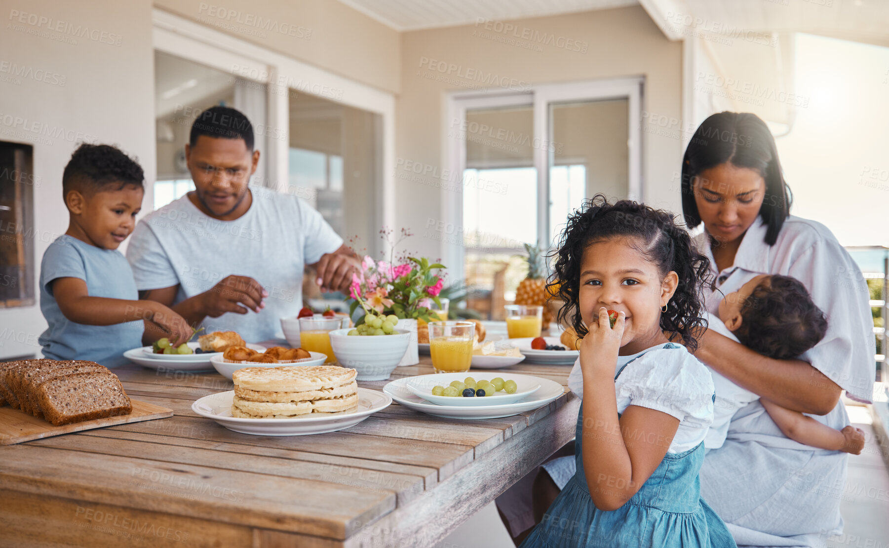 Buy stock photo Shot of a young family having lunch together at home