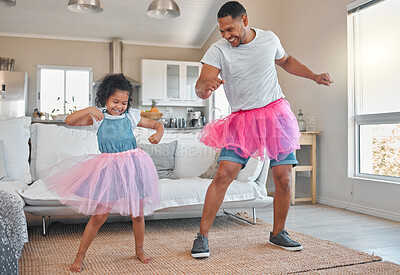 Buy stock photo Shot of a father and daughter dancing in the living room together at home