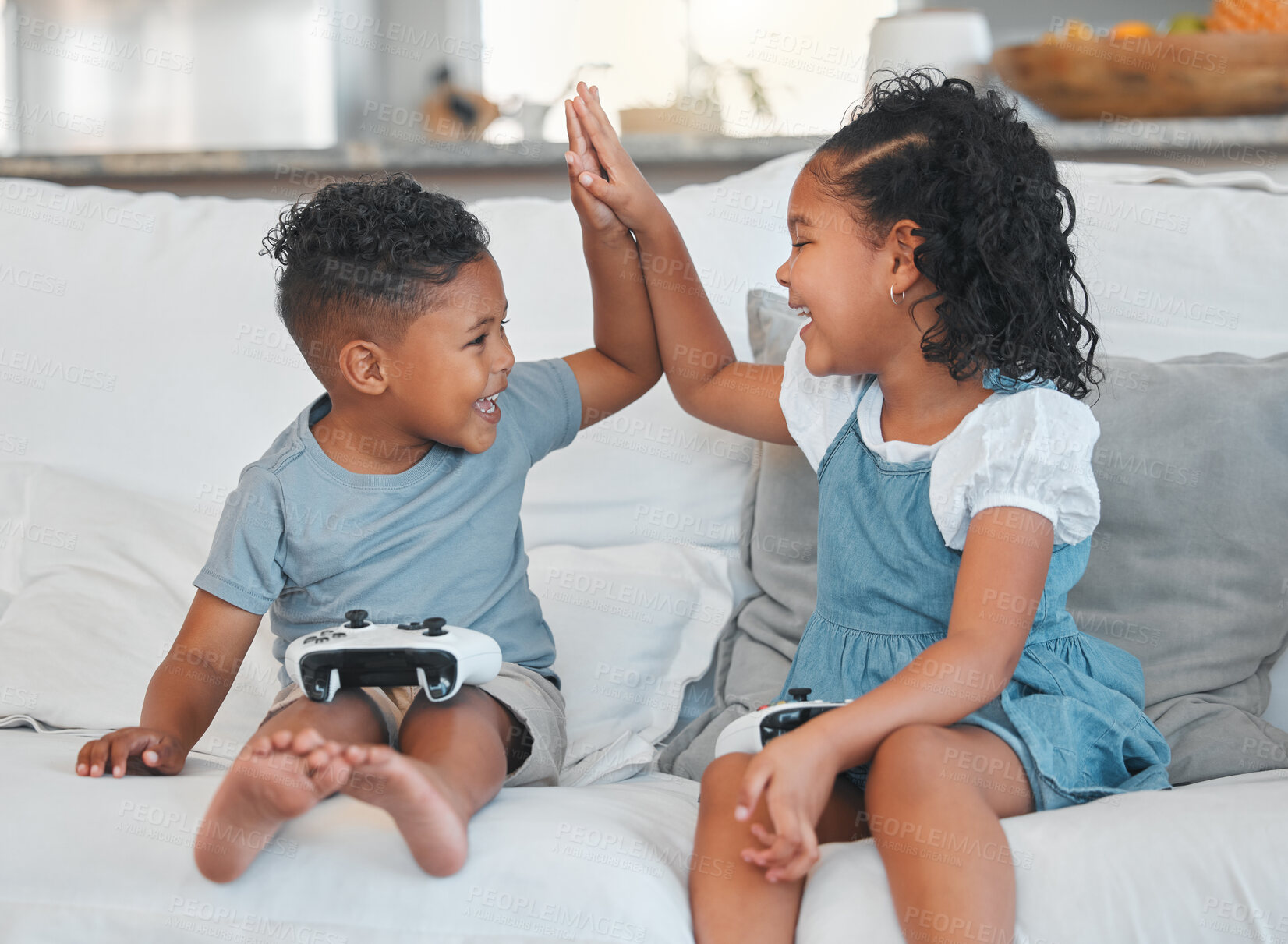 Buy stock photo Children, brother and sister with high five for video game, winning and happy with memory on sofa. Kids, partnership and motivation with controller, bonding and connection with smile in family home