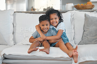 Buy stock photo Shot of a brother and sister spending time together on the sofa at home