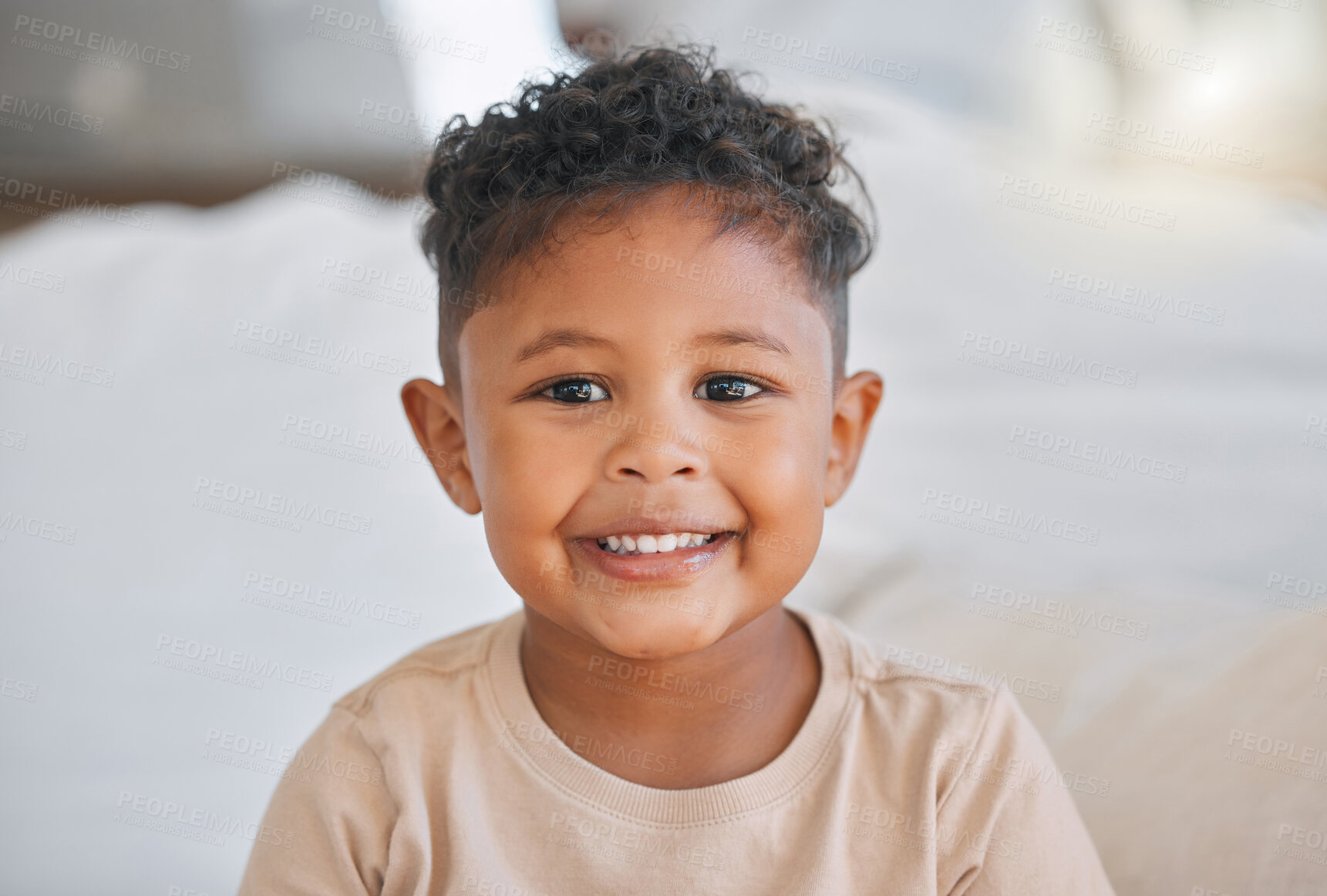 Buy stock photo Boy, portrait and smile in home with happy, growth and development in family bedroom. Weekend, youth and sweet African child from Zimbabwe in the morning with joy, confidence and relax by bed