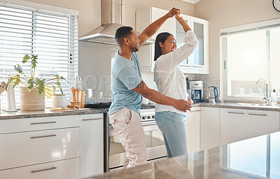 Buy stock photo Love, spin and happy couple dance in kitchen for romantic relationship, support or bonding. Music, man and woman moving in home to celebrate anniversary, marriage and holding hands to twirl partner