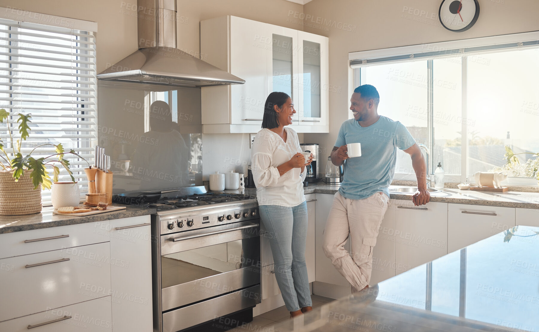 Buy stock photo Kitchen, couple and happy with coffee on conversation for bonding, love snd support with laughing. People, relationship and smile or joyful with cup of tea at home on break, relax and chilling