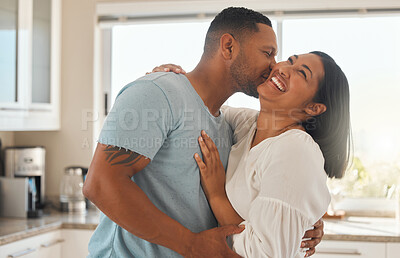 Buy stock photo Kitchen, couple and smile with cheek kiss for love with bonding, support and care. People, relationship and home with laughing or happy for funny conversation, affection and trust for break to relax