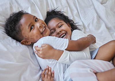 Buy stock photo Shot of a brother and sister laying in bed at home
