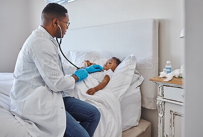 Buy stock photo Shot of a male doctor visiting a little boy at home