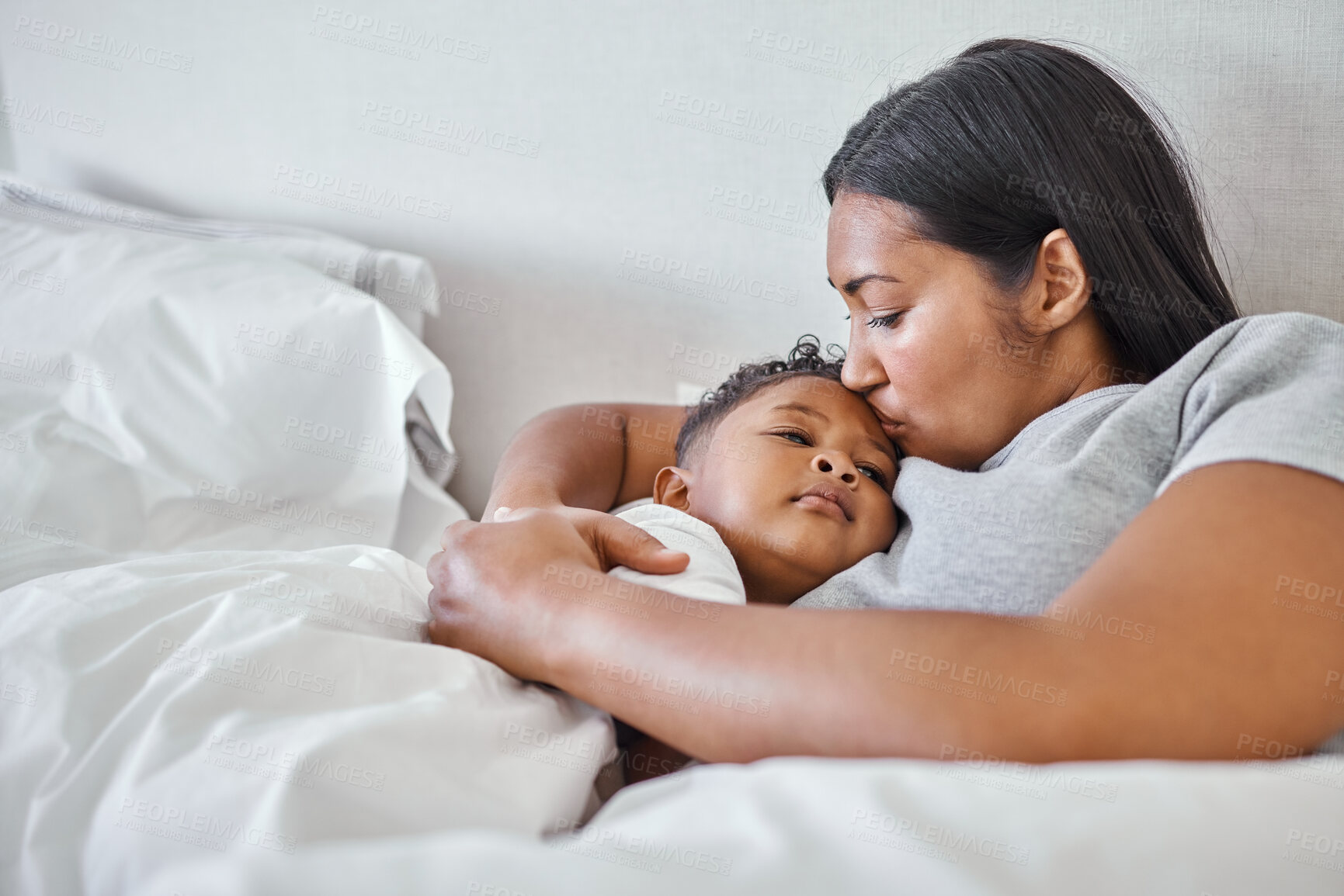 Buy stock photo Mother, relax and sick son in bedroom with kiss for recovery, healthcare support and monitor child of healing. Woman, boy and help with embrace for nursing illness, virus problem and bonding at house